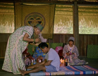 Roger Bardales performing a cleansing ceremony with Mapacho tobacco smoke in the Amazon rainforest.