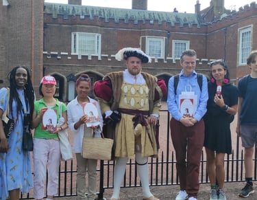 a group of people standing in front of St James's Palace with Henry VIII