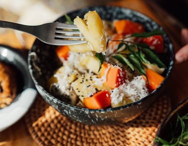 a person holding a fork and fork in a bowl