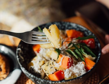 a person holding a fork and fork in a bowl