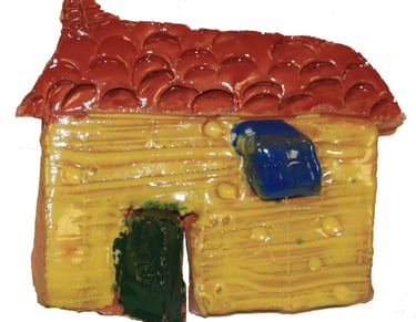 a glazed tile in the shape of a house