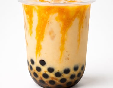 Mango bubble tea with black tapioca pearls and fruit syrup drizzle in a cup