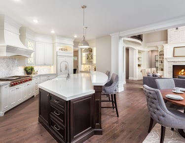 Newly built kitchen featuring custom cabinetry, countertops, flooring, and lighting