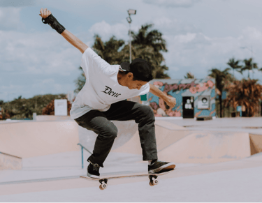a man in a white shirt is doing a trick on a skateboard