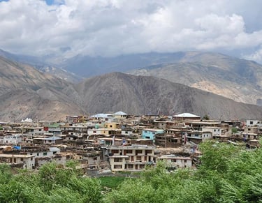 a mountain village in the mountains with a view of the mountains