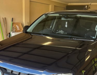 Close-up of a dark blue 4x4 parked in a garage after ceramic paint protection applied