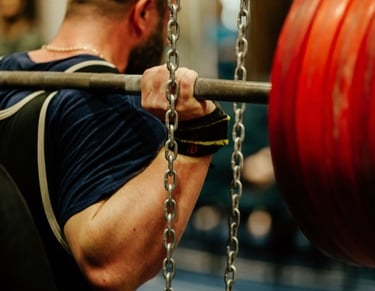 a young man squatting weights