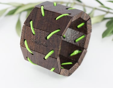 wooden bracelet made from wenge wood and green elastic cord