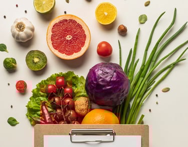 a clipboard with assortment of cut fruit and vegetables