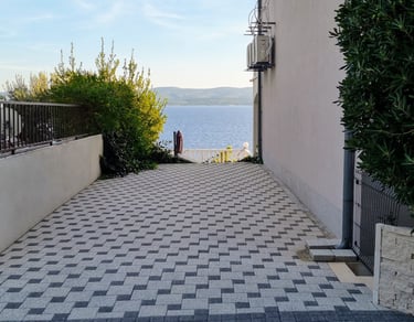 The picture shows private parking for guests and a sea view.