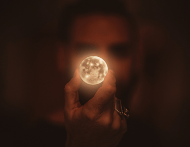 a person holding a light up in the dark