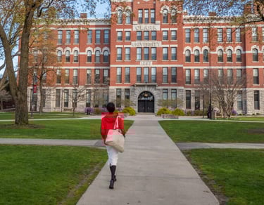 Student in red jacket on Clark University campus, showcasing pathways to academic excellence
