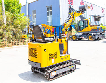 a yellow excavator is parked in front of a building