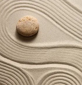 a stone in a sand dune with a stone in the sand