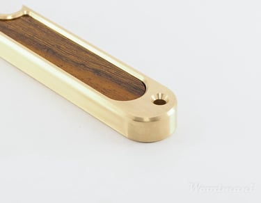 detail of bottle opener made from brass and senna wood