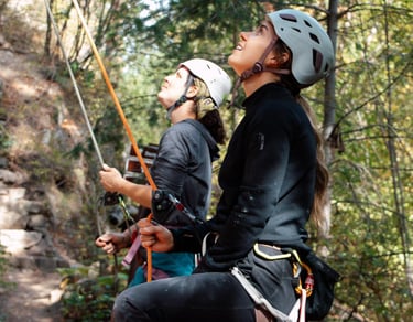 Two people belaying next to each other. Photo credit: Brynn Weigelt.