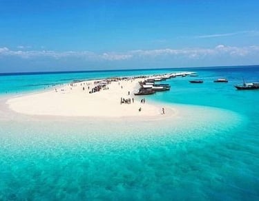 A stunning aerial view of Nakupenda Sandbank in Zanzibar, Tanzania, showcasing pristine white sand, turquoise waters
