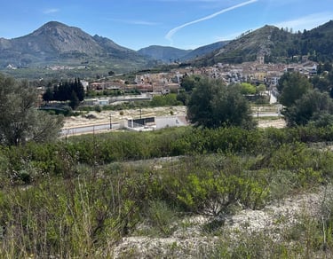 Vue panoramique d’un village de montagne espagnol traditionnel sous un ciel bleu, entouré de colline
