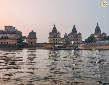 Scenic view of Orchha's royal cenotaphs from the Betwa River boat ride.