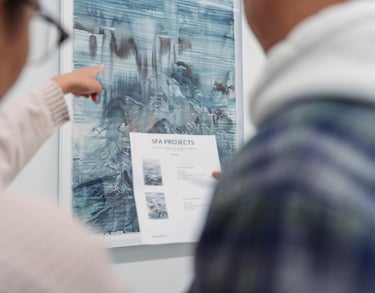 Business team at a gallery reviewing art installation plans.