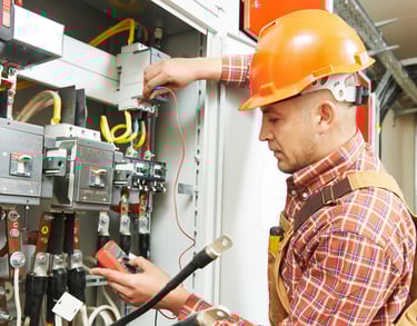 Certified technician performing electrician repair service for a residential home.