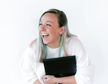 tabitha with butterfly effect consulting laughing with her laptop