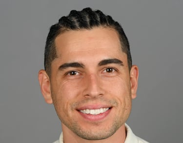 Daniel Alvarez in a cream shirt and tie