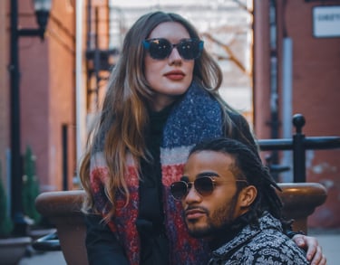 Two young adults wearing fashion sunglasses in an alley of Fort Collins, Colorado