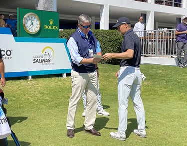 Casey handing Justin Thomas his scorecard.