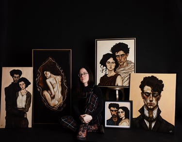 Artist manef photographed with a selection of original portrait paintings