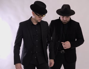 two men in suits and hats standing next to each other