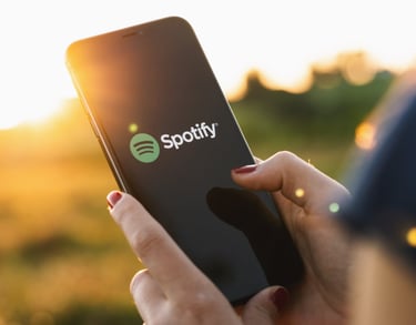 Person holding up phone with Spotify