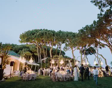 Evening wedding reception at Villa El Rincon with chandeliers and garden dining