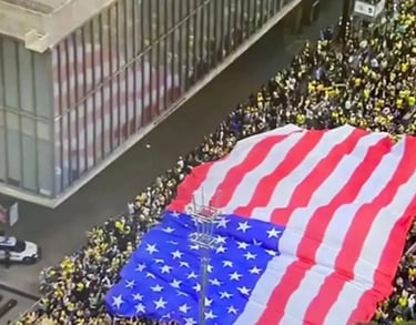 a large flag - drapeded flag on a city street