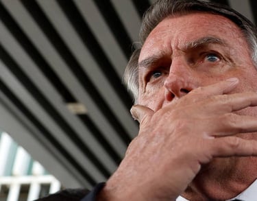 a man in a suit and tie is holding his hand to his chin