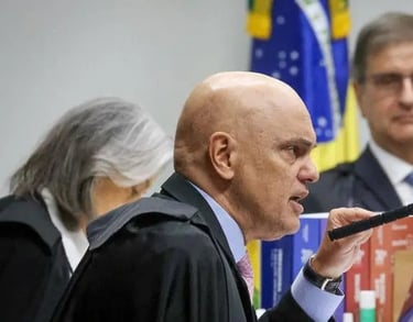 a man in a suit and tie is speaking into a microphone