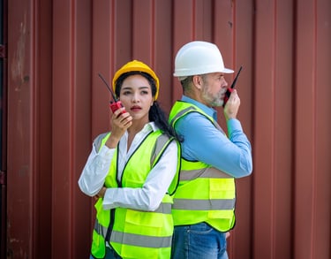 a man and woman in safety vests and hard hats