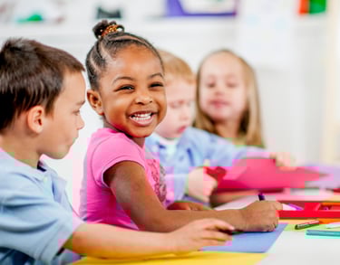 Children smiling and coloring