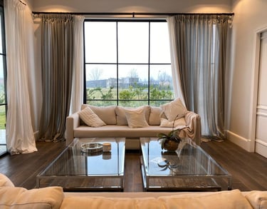a living room with a couch and a glass table
