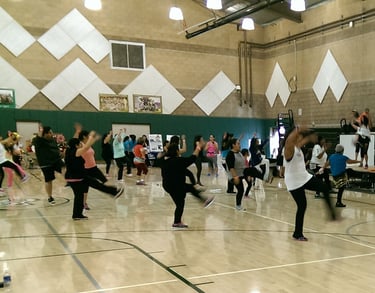 Enhancing Forward Action image of a group of people doing zumba.
