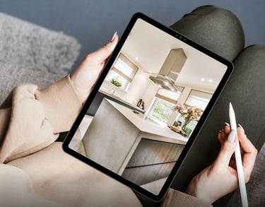 A person viewing a high-quality real estate virtual tour on a tablet, showcasing a modern kitchen