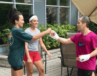 A woman is giving a fist bump to MARK RECAIDO after training Jeet Kune Do North York!