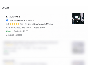 a person holding a cell phone in front of a photo of a man in a