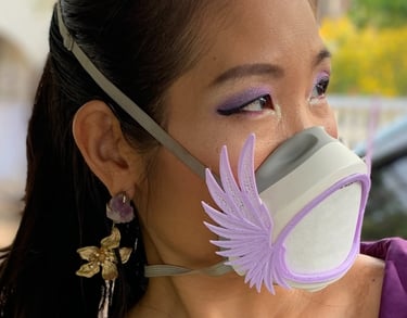 flo-1: Female face with Flomask and Wings Up decoration