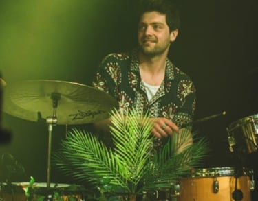 a man playing drums in a band