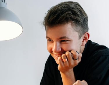 A Young Man Beside a Woman Sitting at Table Holding a Stylus