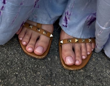 a person wearing sandals and a pair of sandals