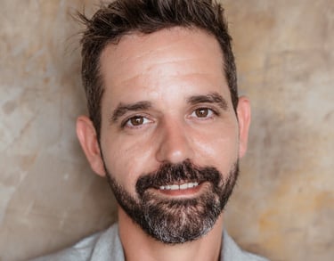 Michael Franco, HR strategist and workplace culture expert, wearing a white shirt and grey blazer in