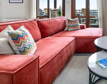 Living room seating area with large TV and sea view at Theseus Retreat holiday rental