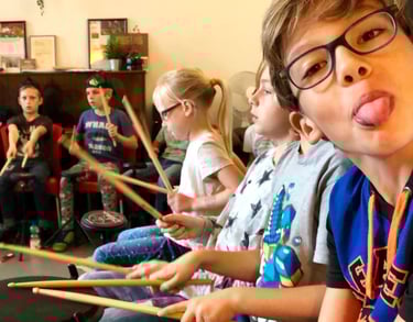 a boy playing drums in a classroom
